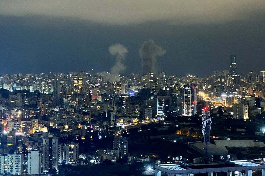 Smoke plumes rise from the site of two Israeli air strikes in the central area of Beirut