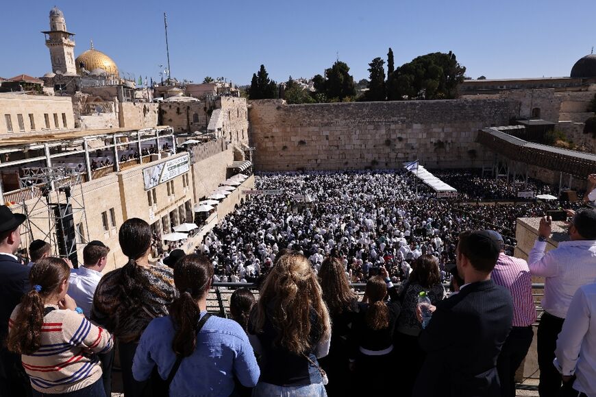 Jewish men, wearing traditional Jewish prayer shawls known as Tallit, gather at the Western Wall in the old city of Jerusalem to perform the annual Cohanim prayer during the holiday of Sukkot