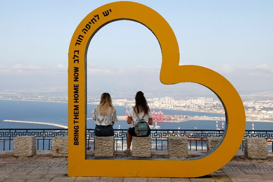 A message in support of hostages held by Hamas militants in Gaza frames two Israelis overlooking Haifa, an area that has come under attack from Hezbollah in Lebanon