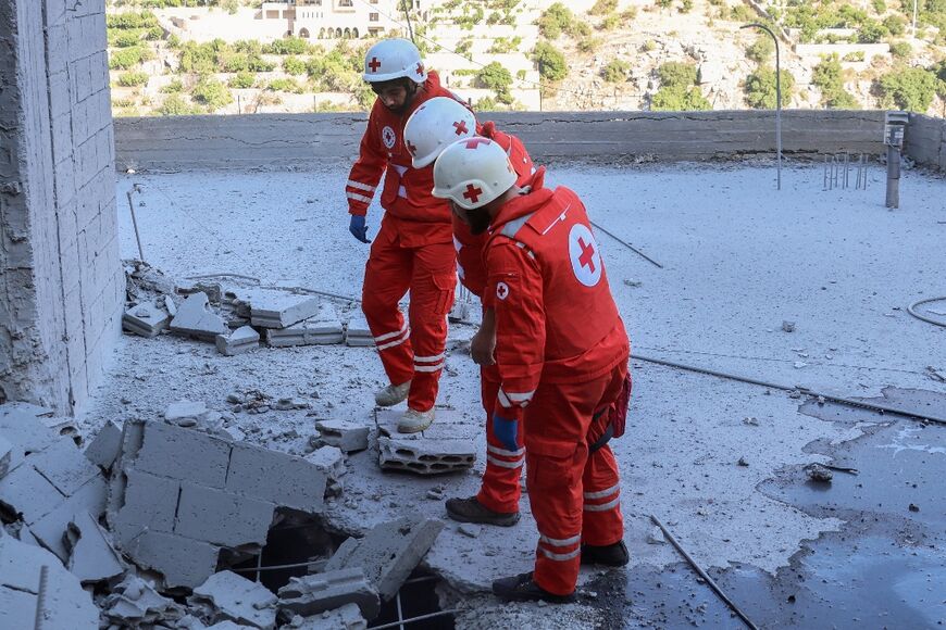 Members of the Lebanese Red Cross inspect damage after an Israeli bombardment