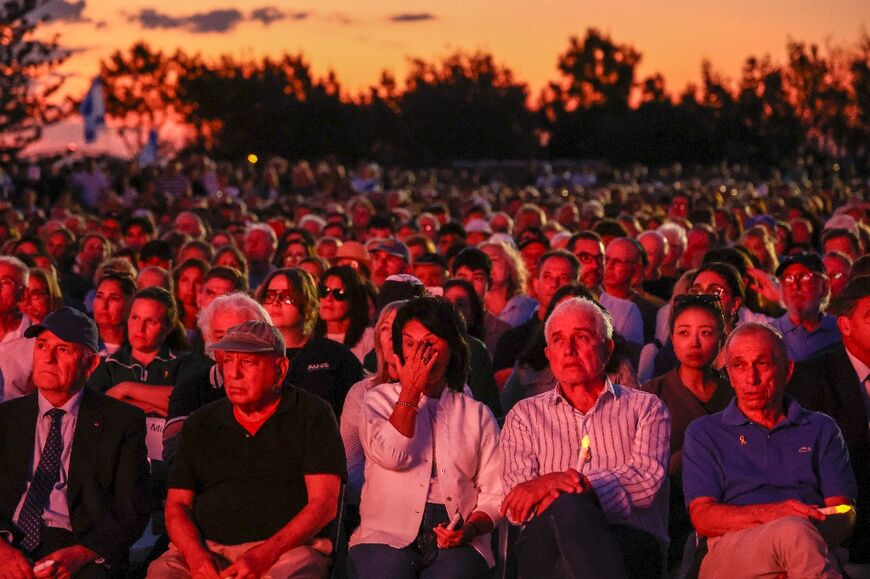 Members of the Australian Jewish community react as they listen to speeches during a memorial service in Sydney