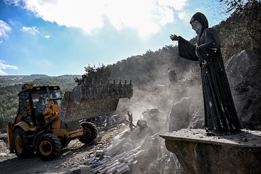 A bulldozer moves rubble in the Christian-majority village 