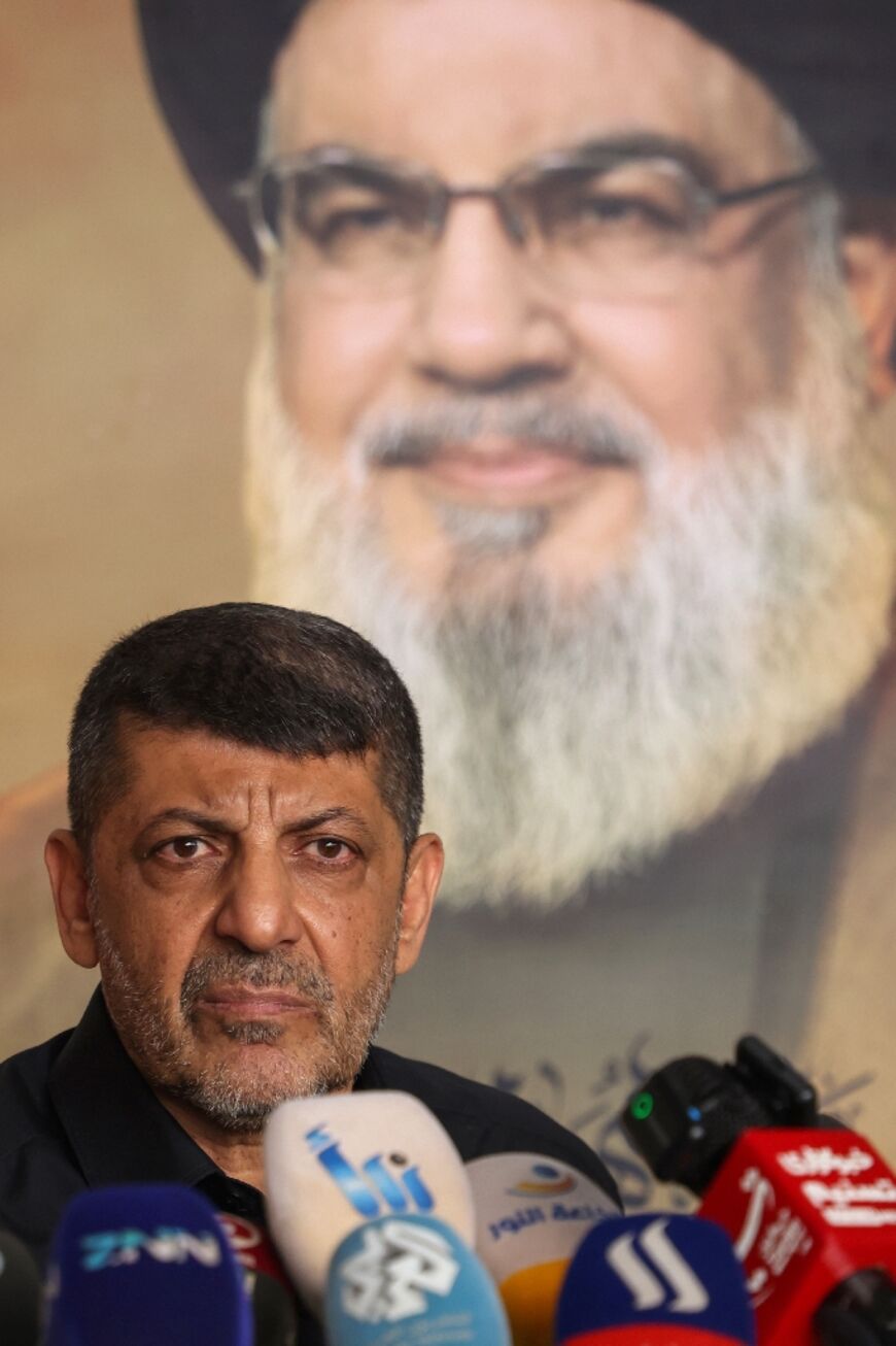 Hezbollah spokesman Mohammed Afif pictured at a November 11 Beirut press conference in front of a portrait of Hassan Nasrallah