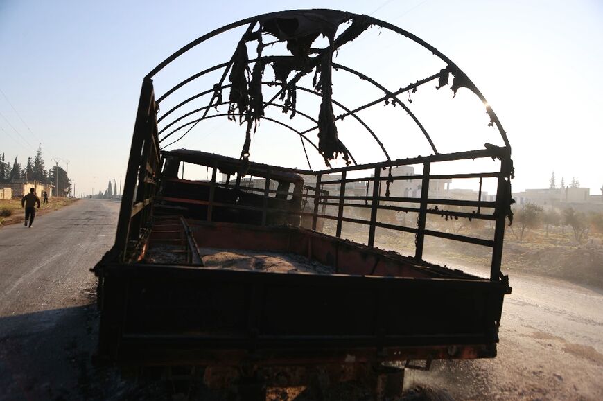 A burned Syrian Army vehicle in Khan al-Assal district which jihadists and their Turkish-backed allies took over, in Syria's Aleppo province