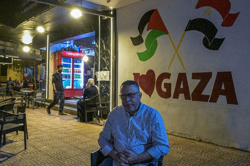 Bassem Abu Aoun in front of his Hay al-Rimal restaurant -- one of many cafes, falafel joints and other shops started in Cairo's 'Little Gaza' by newly arriving Palestinians 