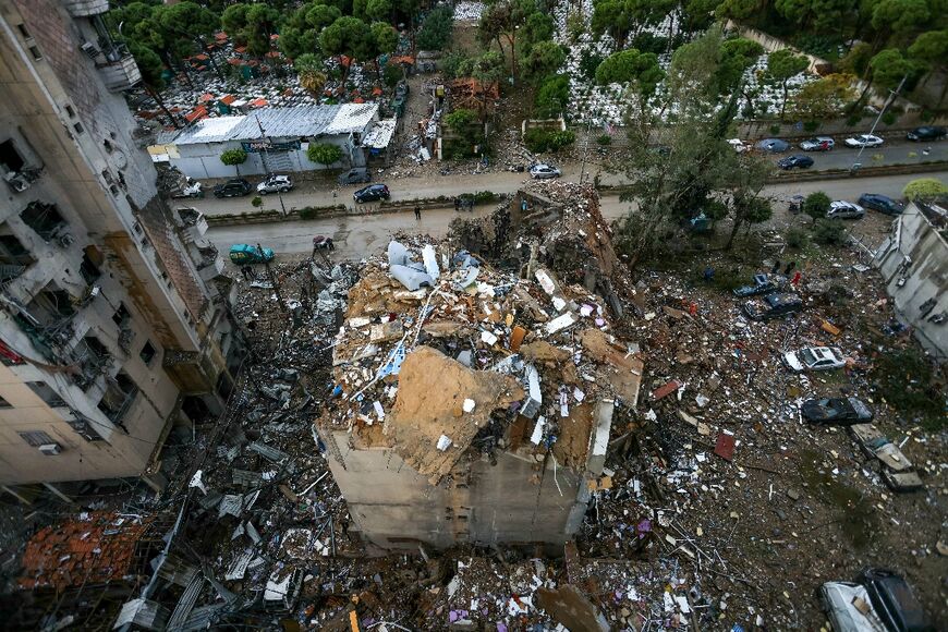 People inspect the damage on Tuesday from an overnight air strike on the Shiyah neighborhood in Beirut's south