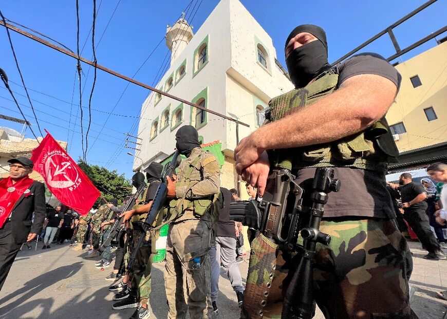 Armed and masked men in Ain al-Helweh refugee camp near Sidon attend the funeral of two Popular Front for the Liberation of Palestine (PFLP) militants, said to have been killed fighting the Israeli army