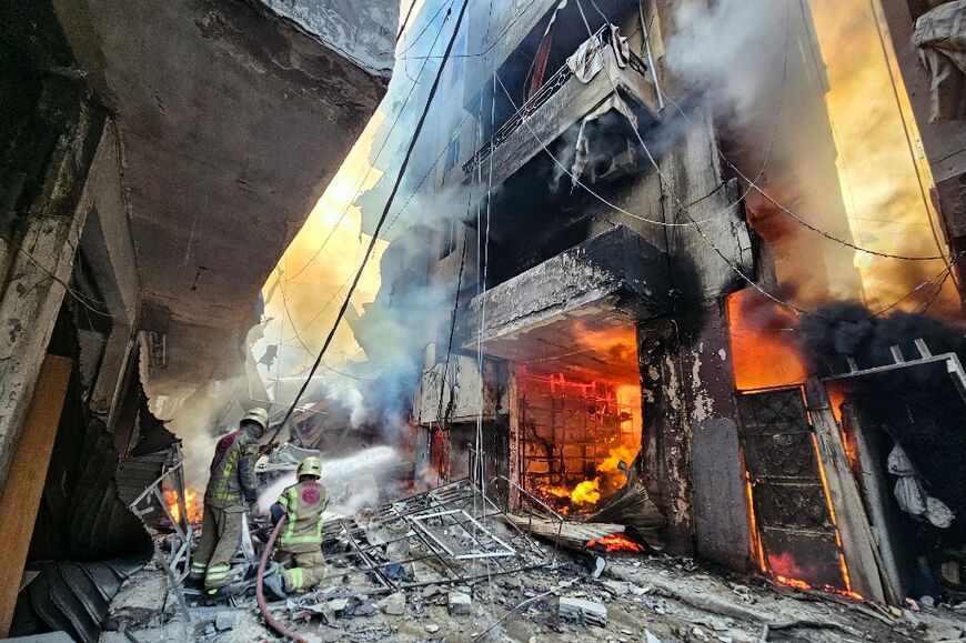 Firefighters battle the flames after an Israeli air strike in the Hadath neighbourhood of Beirut's southern suburbs 