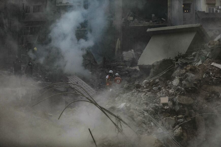 Rescuers search the still smoking rubble for victims and survivors of the levelled building in Basta