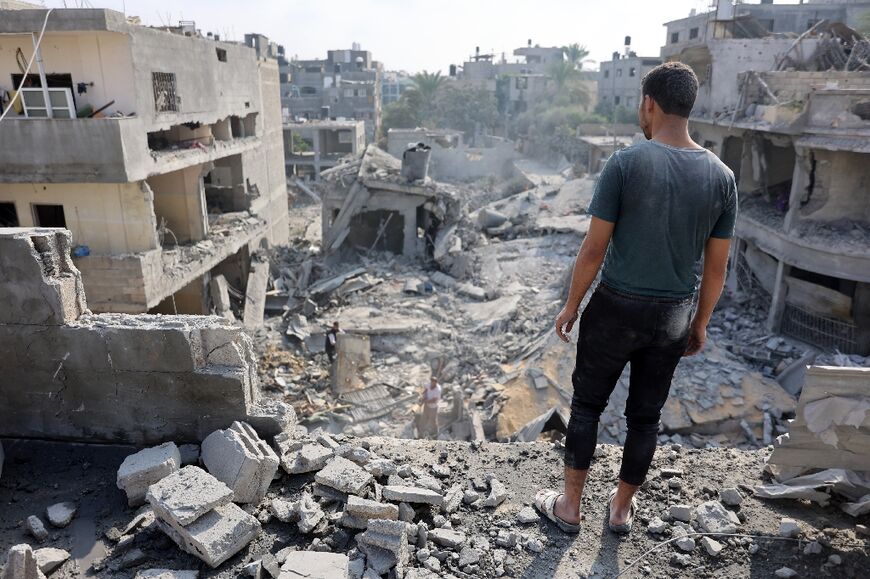 A Palestinian stares at the rubble of the Alloush family's house