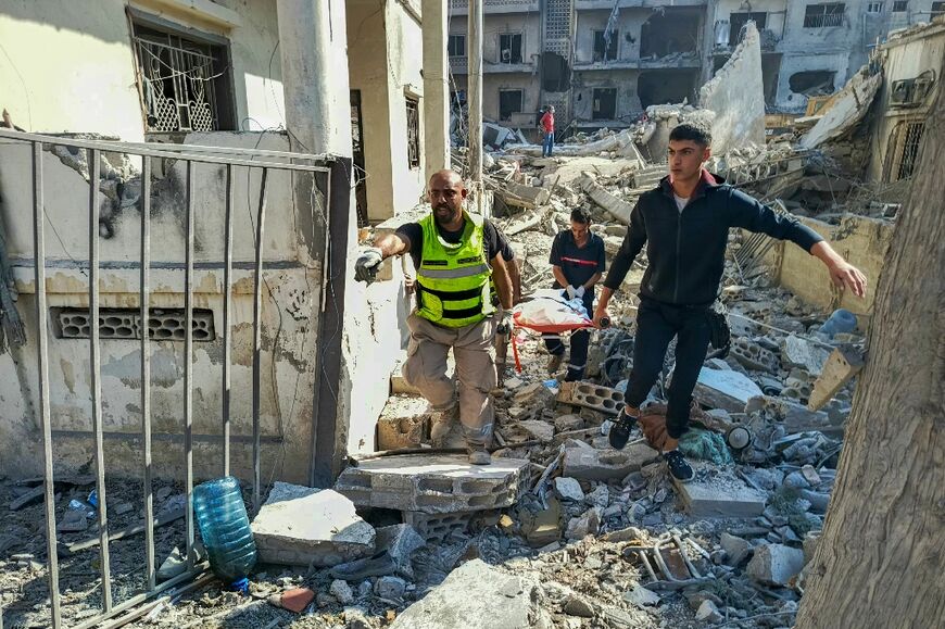 Rescuers at the site of overnight Israeli strikes on the southern Lebanese city of Tyre