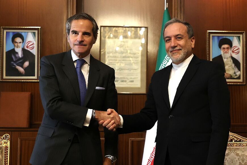 International Atomic Energy Agency chief Rafael Grossi (L) shakes hands with Iranian Foreign Minister Abbas Araghchi before their meeting in Tehran.