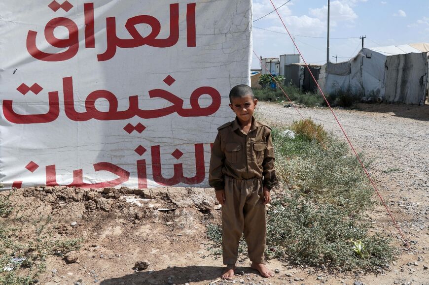 A child at a displacement camp poses for a picture