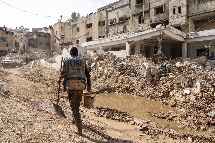 UN workers clean up after the Israeli raid