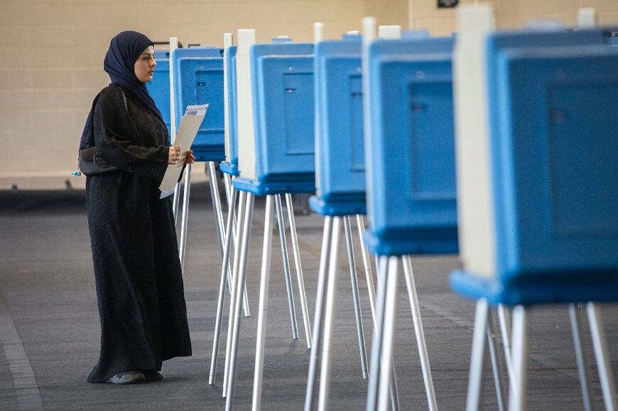 Voters cast their ballots during Michigan's early voting period on October 29, 2024 in Dearborn, Michigan