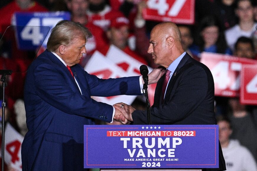 Incoming US President Donald Trump greets Dearborn Heights, Michigan, Mayor Bill Bazzi  during a campaign rally at the Suburban Collection Showplace in Novi, Michigan