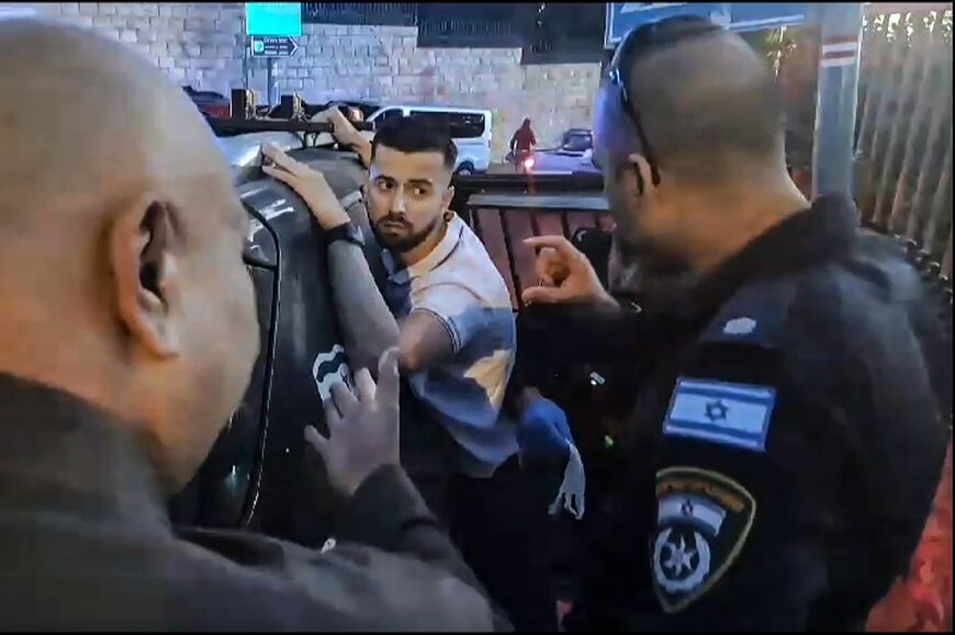 In this image grab taken from AFPTV video footage, Israeli police detain a French gendarme at  the Eleona Domain in Jerusalem