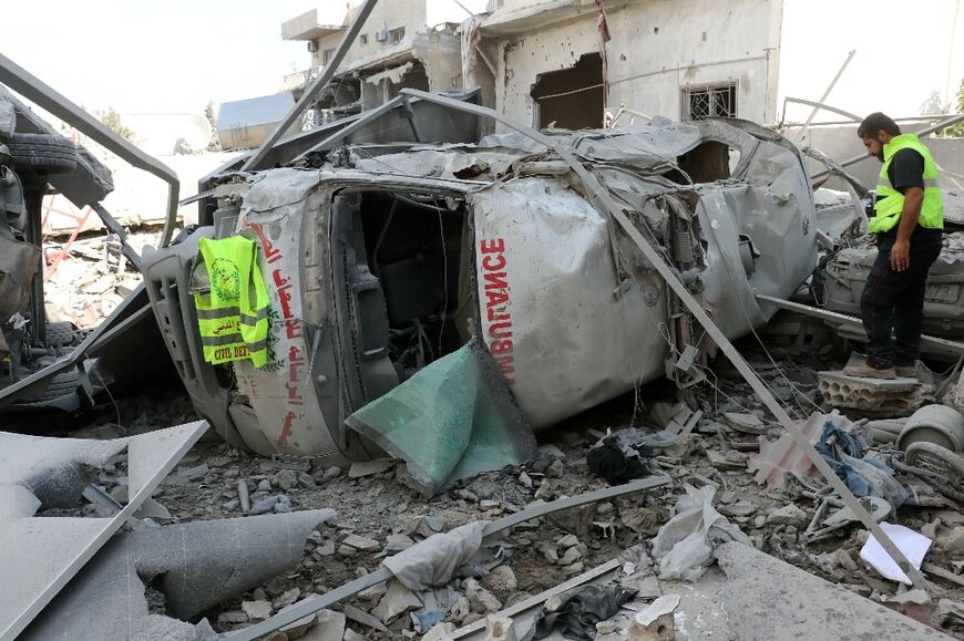 A rescuer with the Risala Scouts association, linked to Hezbollah's ally Amal, stands in front of a destroyed ambulance a day after a deadly Israeli strike hit the organisation's headquarters in the southern Lebanese village of Deir Qanun