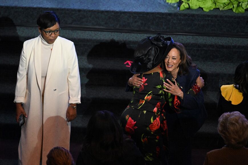 US Vice President Kamala Harris hugs a woman as she attends a church service in Detroit, Michigan with just two days left in her US presidential race against Donald Trump