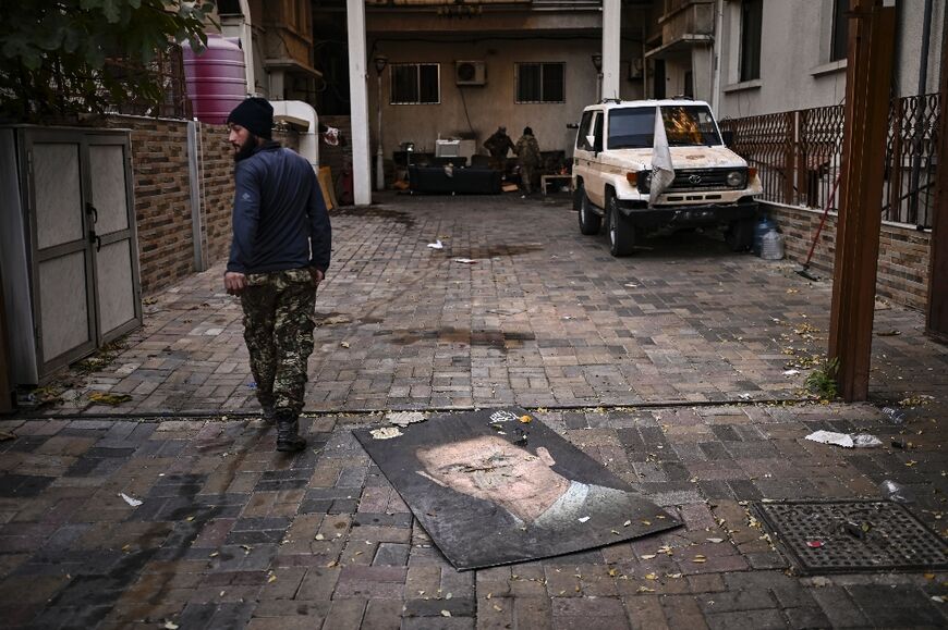 A defaced portrait of ousted president Bashar al-Assad at the Syrian General Intelligence Directorate Branch 251