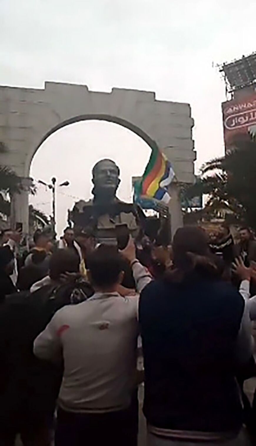 An image grab from a UGC video posted on December 7 shows protesters toppling a statue of Syria's late president Hafez al-Assad in Jaramana, in the southern suburbs of Damascus