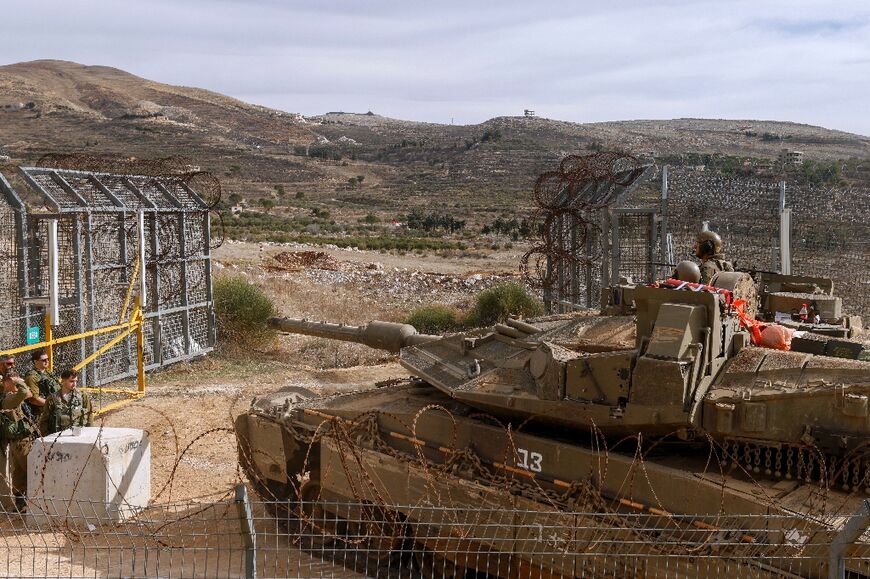 Israeli forces cross the fence to the buffer zone with Syria, near Majdal Shams in Israel-annexed Golan Heights