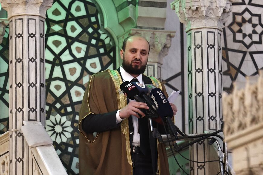 Syria's interim prime minister Mohammad al-Bashir addresses a crowd at the Umayyad Mosque in Damascus