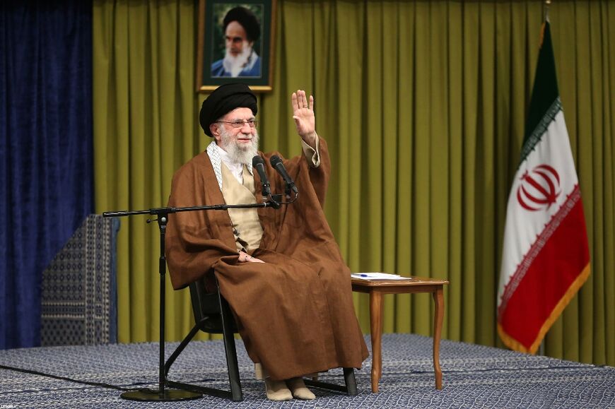 This handout picture released by the office of Iran's Supreme Leader Ayatollah Ali Khamenei shows him greeting people as he makes a speech in Tehran