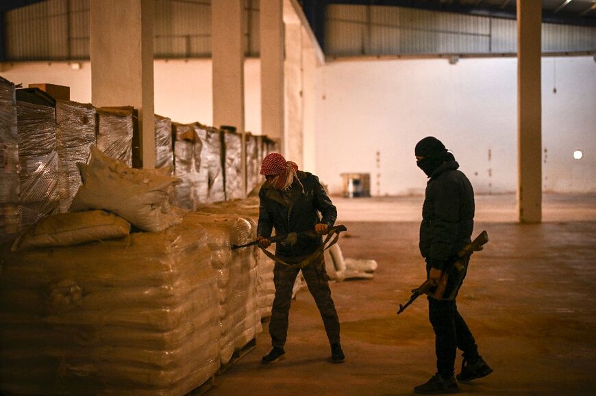 Syrian rebel inspect sacks marked as 'Saudi-made' caustic soda, a key ingredient in the production of methamphetamine