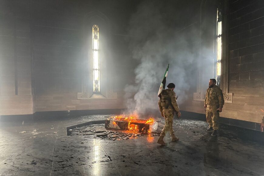 Rebel fighters set fire to the tomb of Assad's father and predecessor Hafez in their home village of Qardaha in the hills above the Mediterranean coast.