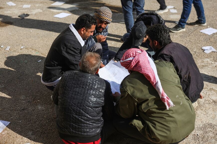 Relatives read prison registers in the search for their loved ones