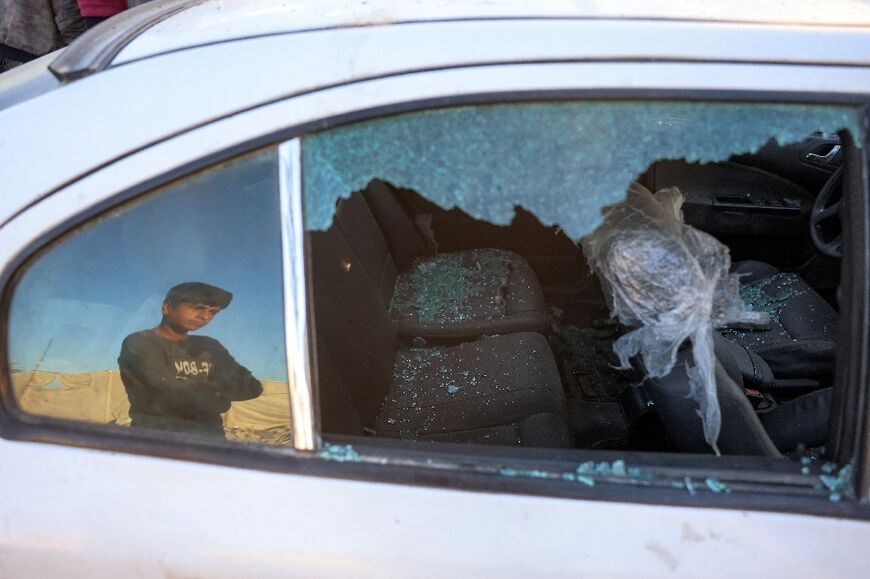 A damaged vehicle at the site of a reported Israeli strike in the southern Gaza Strip