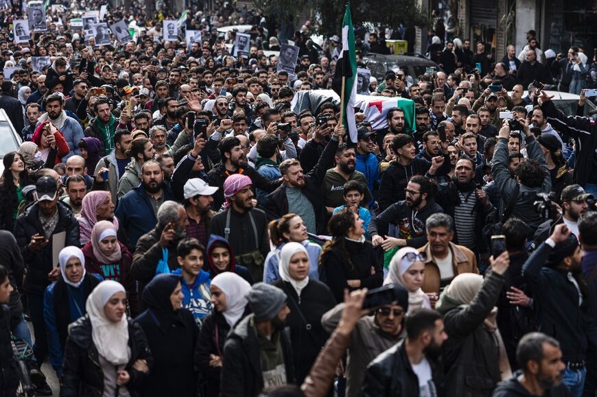 Mourners in Damascus attend the funeral of Syrian activist Mazen al-Hamada, whose body was found after rebels took control of the capital