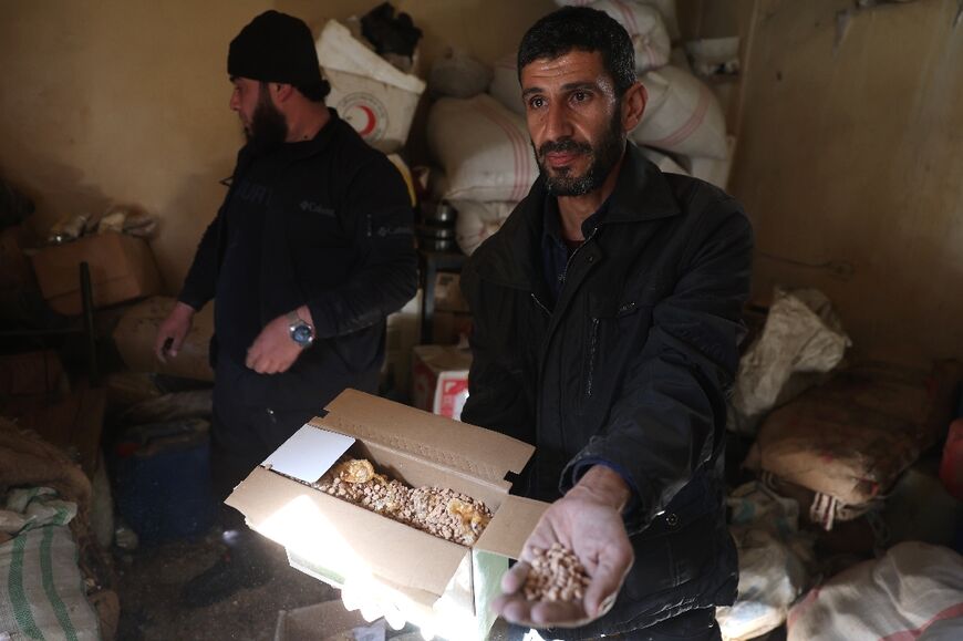 A man displays a box of what security officials said were captagon tablets in Damascus on Wednesday