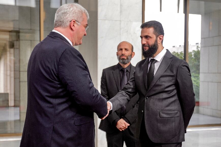 Syria's de facto leader Ahmed al-Sharaa (R), now sporting Western-style suits in place of his rebel fatigues, has received a flurry of diplomatic visits, including Ukrainian Foreign Minister Andriy Sybiga on Monday.