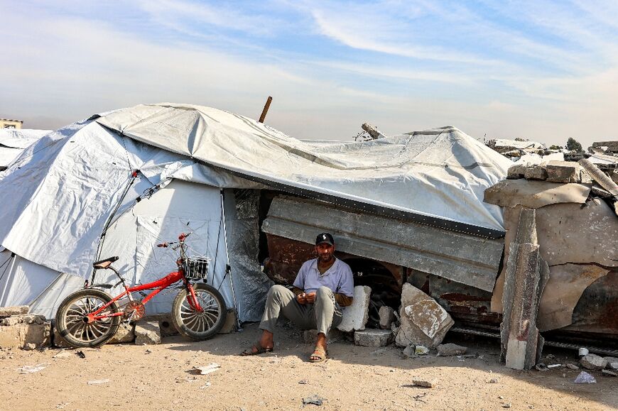 A man outside a tent at a shelter for displaced Palestinians in Gaza City