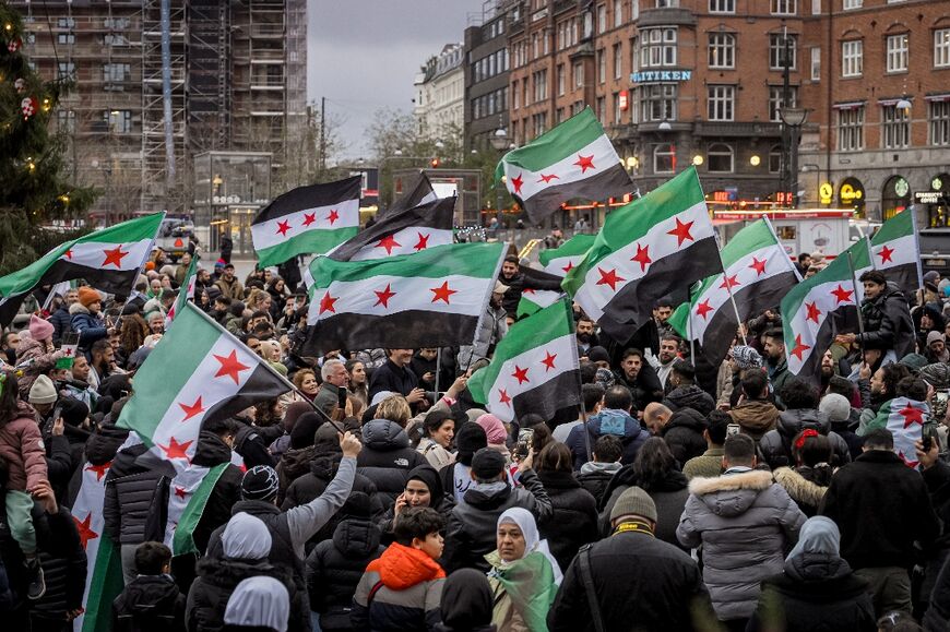 Members of the Syrian community wave Syrian flags on December 8, 2024 in Copenhagen, Denmark, as they rally to celebrate the end of Syrian dictator Bashar al-Assad's rule 