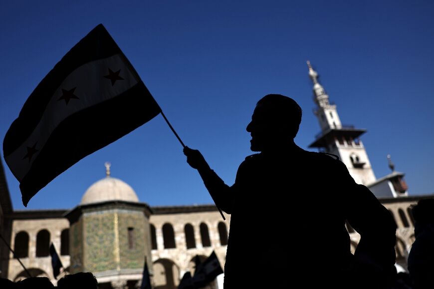 A flag-waving worshipper outside the Umayyad Mosque ahead of Friday noon prayers