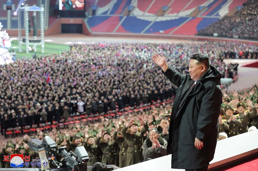 North Korean leader Kim Jong Un waves at a new year performance at May Day Stadium in Pyongyang