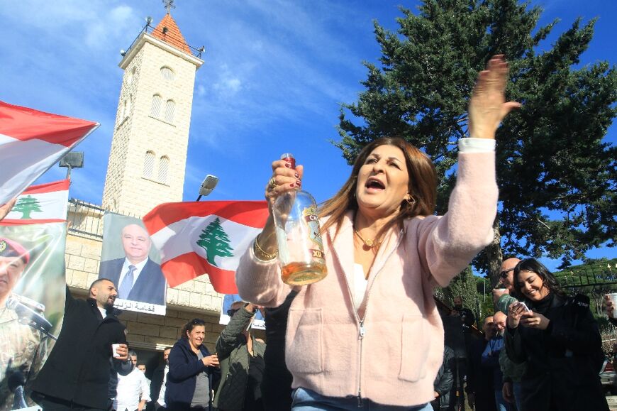 People dance and drink to celebrate the election of their village's native Joseph Aoun as Lebanon's president