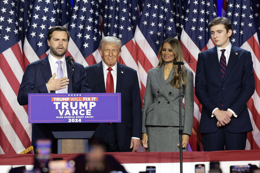 WEST PALM BEACH, FLORIDA - NOVEMBER 06: Republican vice presidential nominee, U.S. Sen. J.D. Vance (R-OH) speaks as Republican presidential nominee, former U.S. President Donald Trump, former first lady Melania Trump and Barron Trump look on during an election night event at the Palm Beach Convention Center on November 06, 2024 in West Palm Beach, Florida. Americans cast their ballots today in the presidential race between Republican nominee former President Donald Trump and Vice President Kamala Harris, as