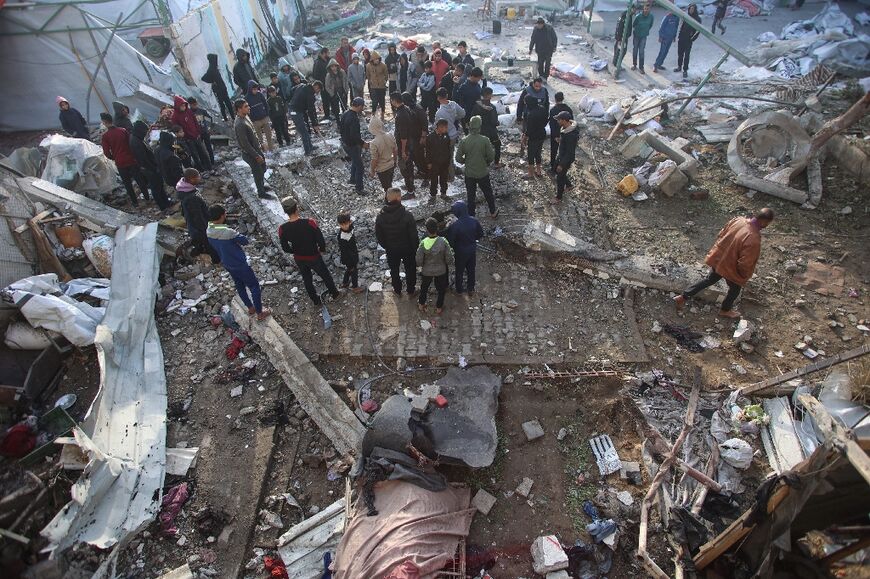 Palestinians at the site of an Israeli strike on a school turned shelter in Gaza City